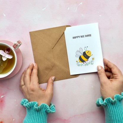 Bee birthday card being taken out of envelope