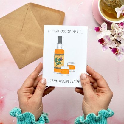 Hands holding Whisky anniversary Card