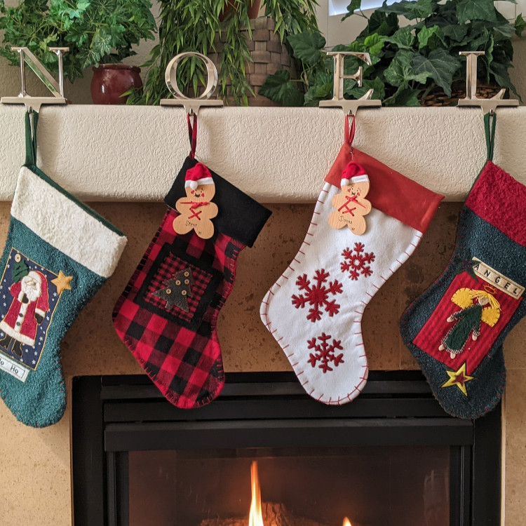 Personalised stocking filler ideas - image shows row of Christmas stockings by fireplace