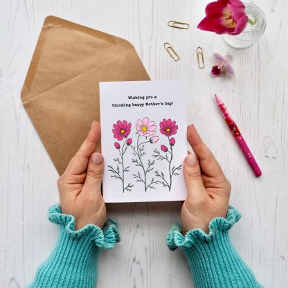 Hands holding Cosmos flowers mother's day card