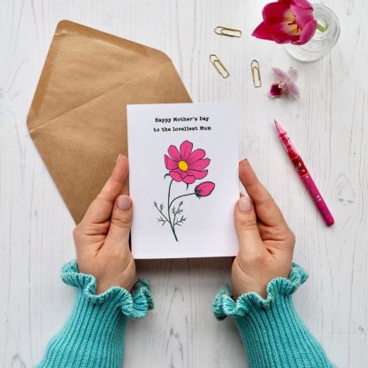 Hands holding cosmos flower mothers day card