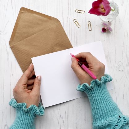 Blank greeting card being written in